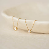 Diamond Pendant Necklace 14k Gold - Johanne with delicate chains displayed on a neutral surface