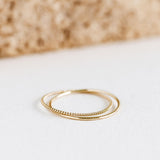 14k Gold Double Ring - Celestina laying on a flat surface