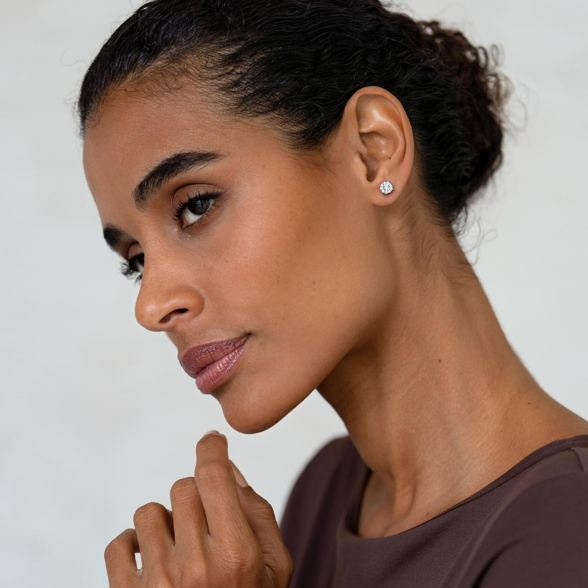 Round-cut diamond earrings on model