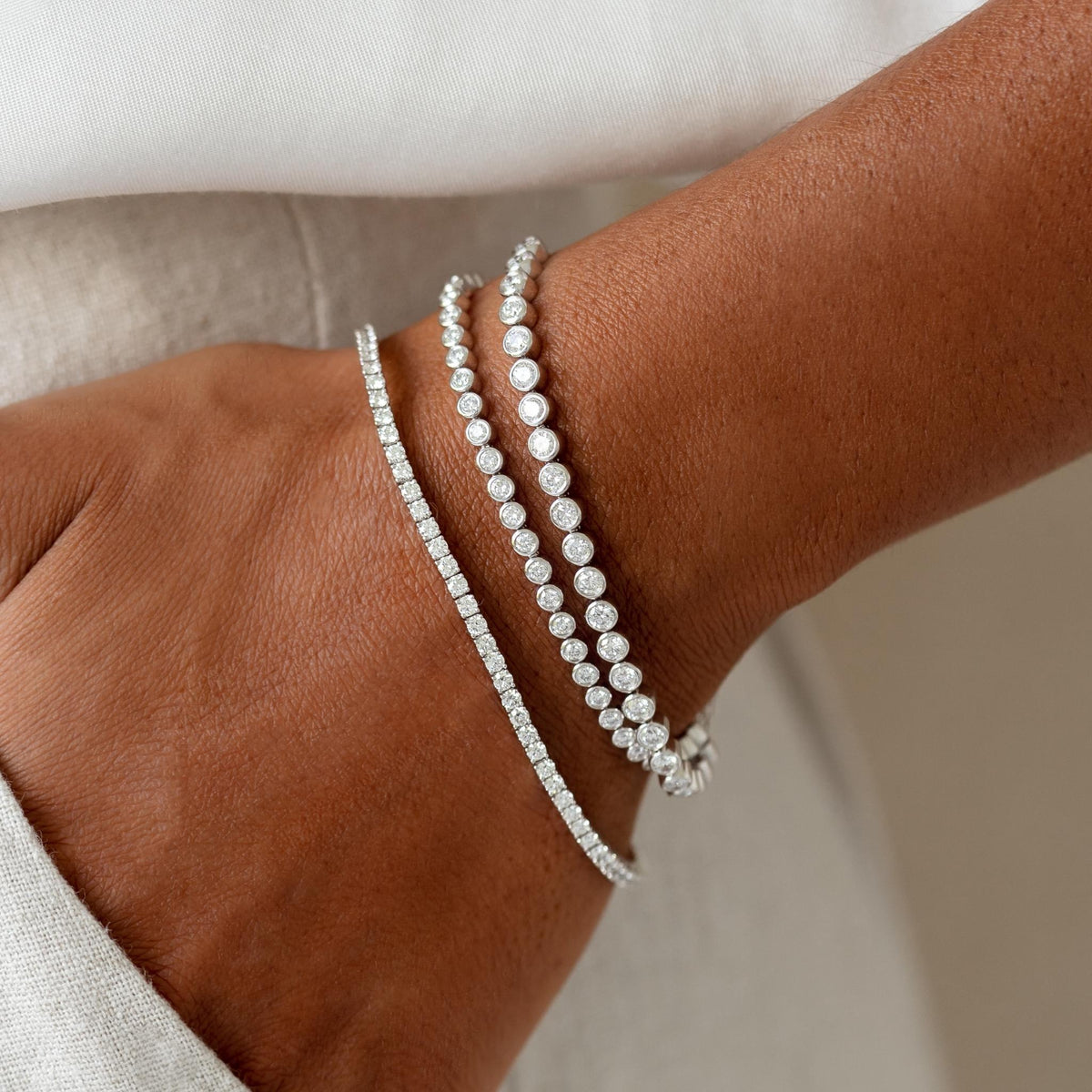 Diamond Tennis Bracelet 14k White Gold (2.6 - 2.7 ct tw, 6.5 inches) on wrist with two other white gold diamond bracelets
