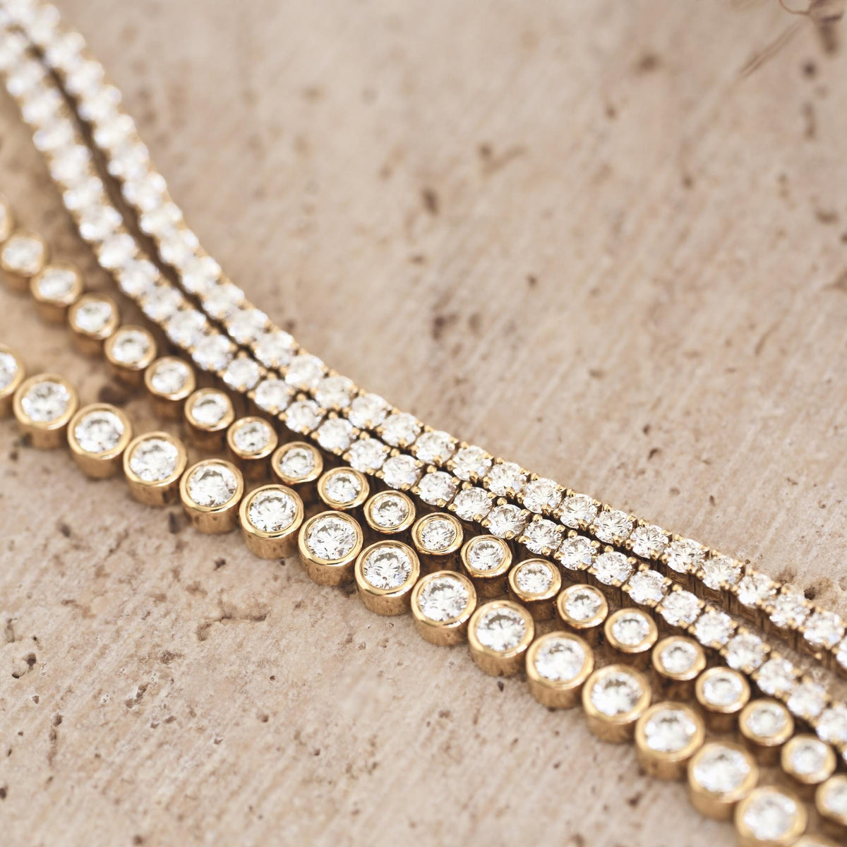 Tennis bracelets with bezel cut and prong set diamonds in 14k gold