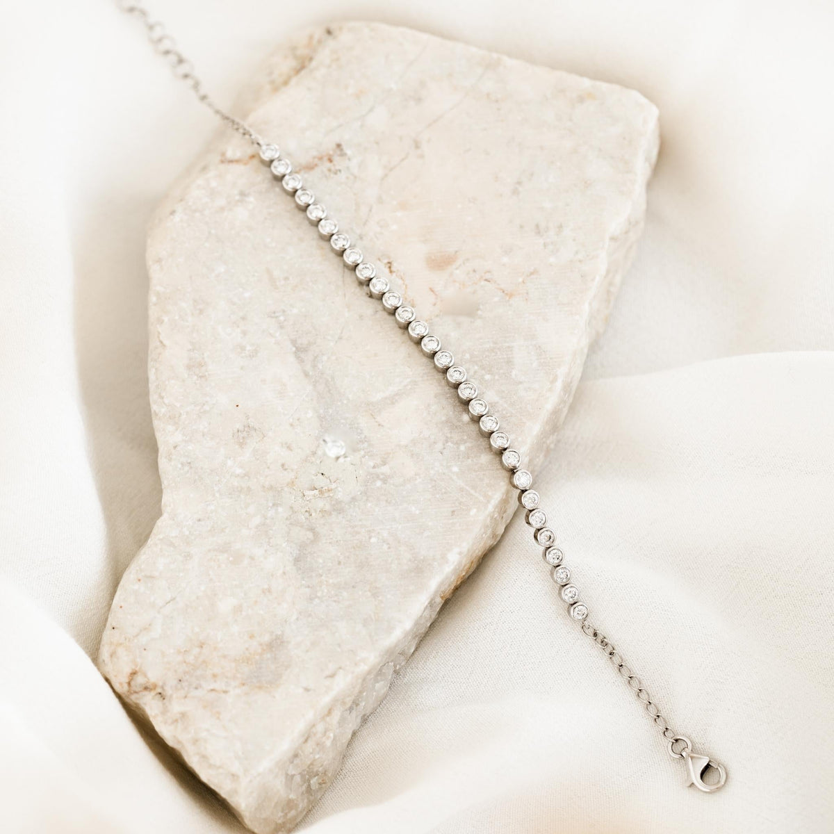 Half Diamond Tennis Bracelet 14k White Gold (0.9 - 1.0 ct tw) with bezel-set round diamonds on a soft neutral backdrop