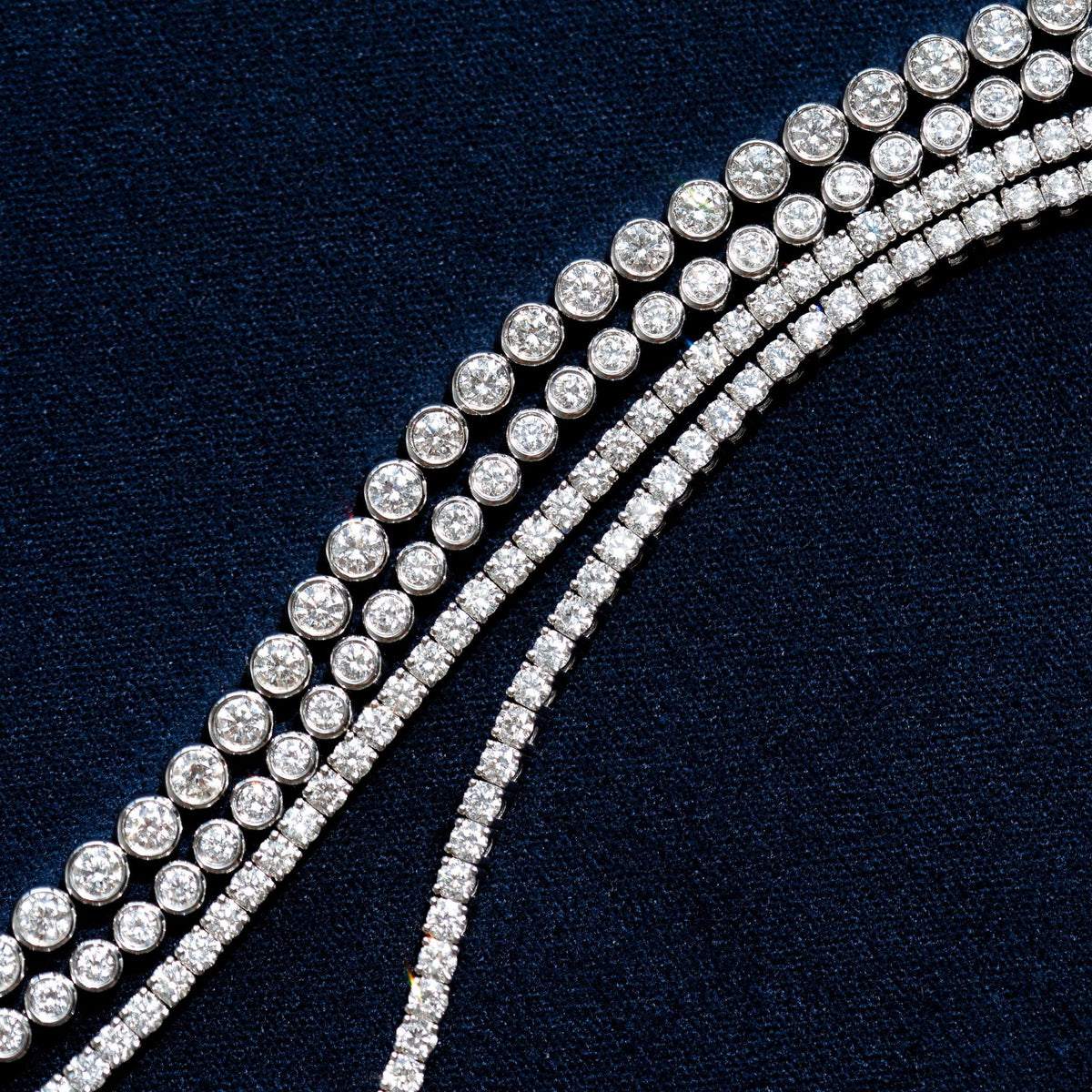Half Diamond Tennis Bracelet 14k White Gold (1.8 - 2.0 ct tw) with bezel-set round brilliant cut diamonds on blue background