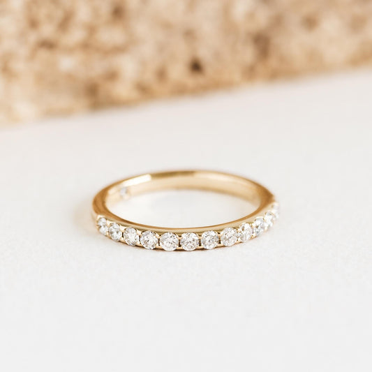 Diamond Half Eternity Ring 14k Gold - Isa with lab grown diamonds set in a delicate gold band on a white surface