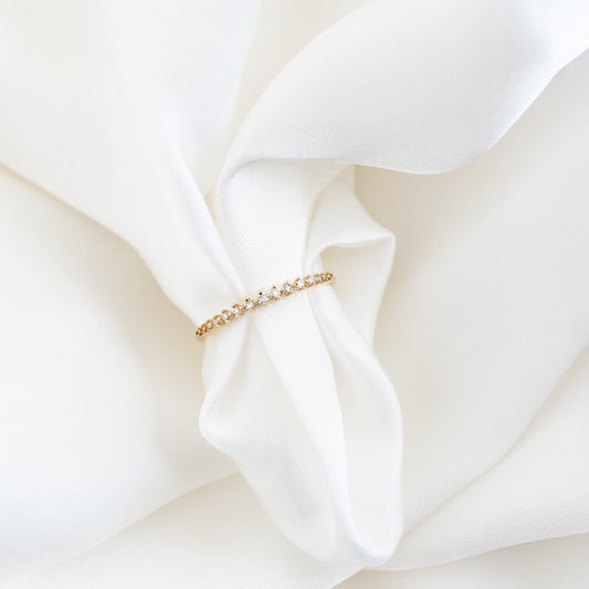 Graduated Diamond Ring 14k Gold - Ophelia featuring 15 varying size lab grown diamonds on a gold band against white fabric