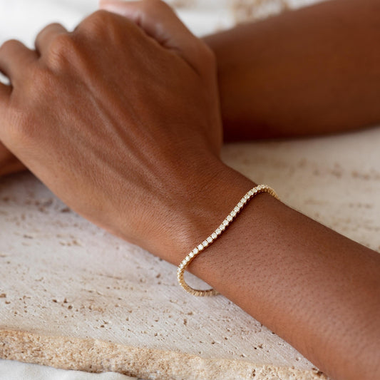 Diamond Tennis Bracelet 14k Yellow Gold (2.9 - 3.0 ct tw, 7 inches) worn on wrist against neutral textured background