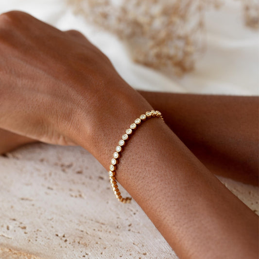 Half Diamond Tennis Bracelet 14k Yellow Gold (1.8 - 2.0 ct tw) on wrist with soft neutral background