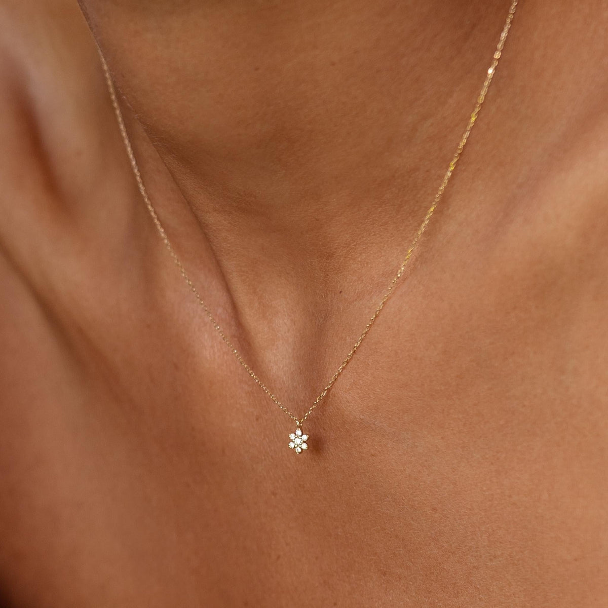 Lab grown diamond flower necklace in solid gold on neck