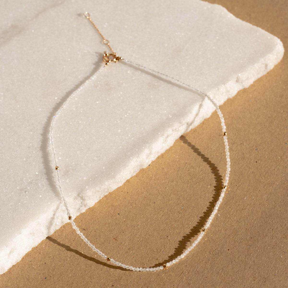 Layering beaded necklace with moonstone crystals in gold