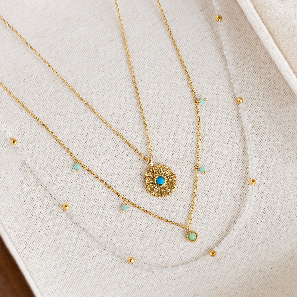 Gold Necklace set with moonstone crystals, pendants and beads