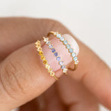Close-up of three March Birthstone Ring 14k Gold - Ombre Blue Topaz rings with gradient gemstones on finger
