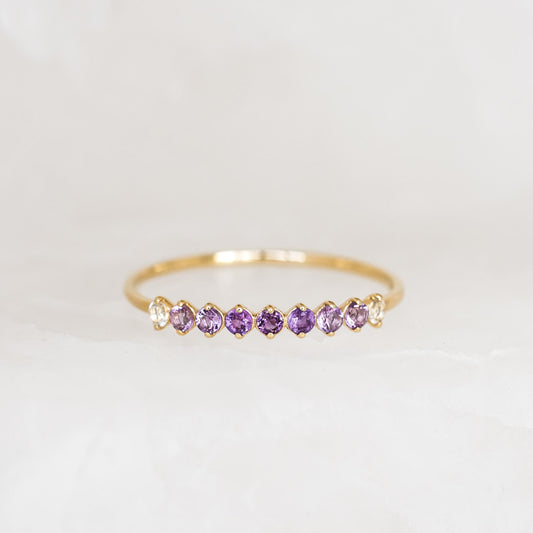 February Birthstone Ring 14k Gold - Ombre Amethyst with graduated purple and white gemstones on a marble background