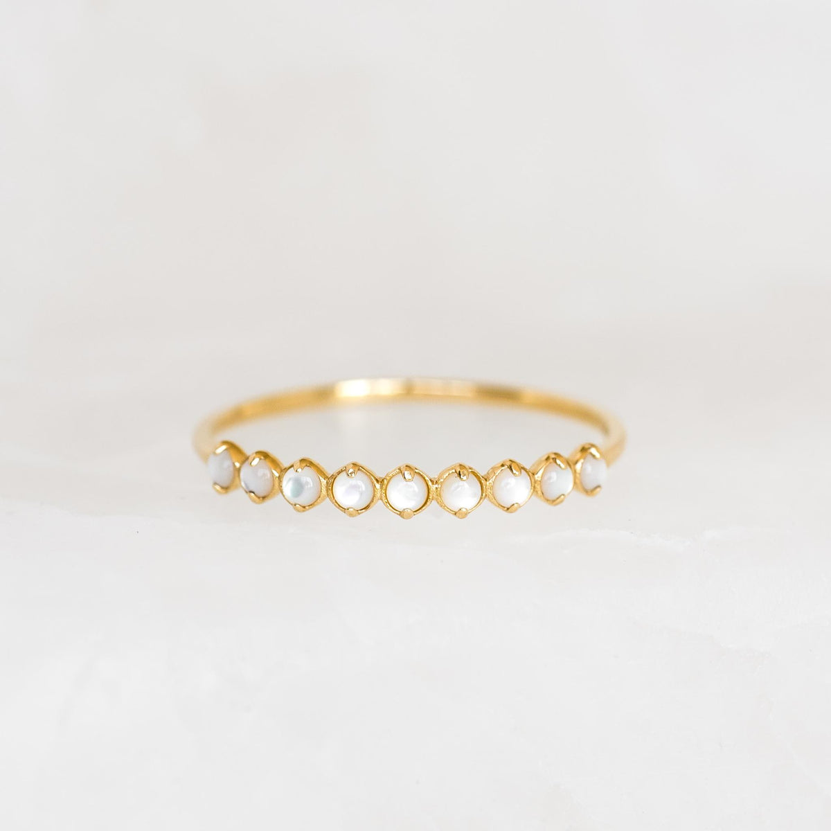 Close-up of June Birthstone Ring 14k Gold - Mother of Pearl featuring nine delicate mother of pearl stones on a gold band