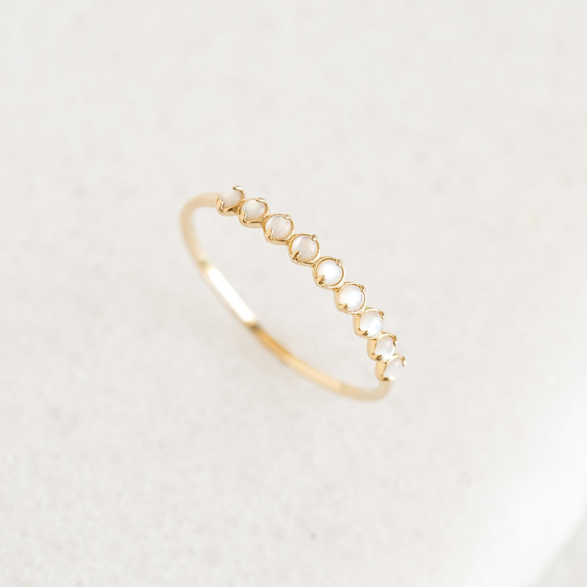 June Birthstone Ring 14k Gold - Mother of Pearl with nine delicate mother of pearl stones on a white background