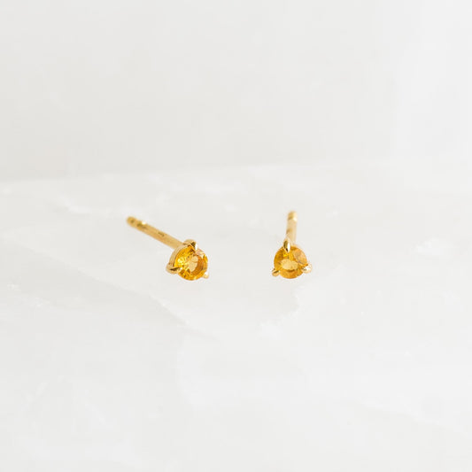 November Birthstone Stud Earrings 14k Gold - Citrine with small round citrine gemstones set in three-prong settings on a white surface
