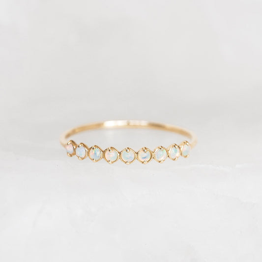 October Birthstone Ring 14k Gold - Opal with nine shimmering opal gemstones set in a delicate gold band on a white background