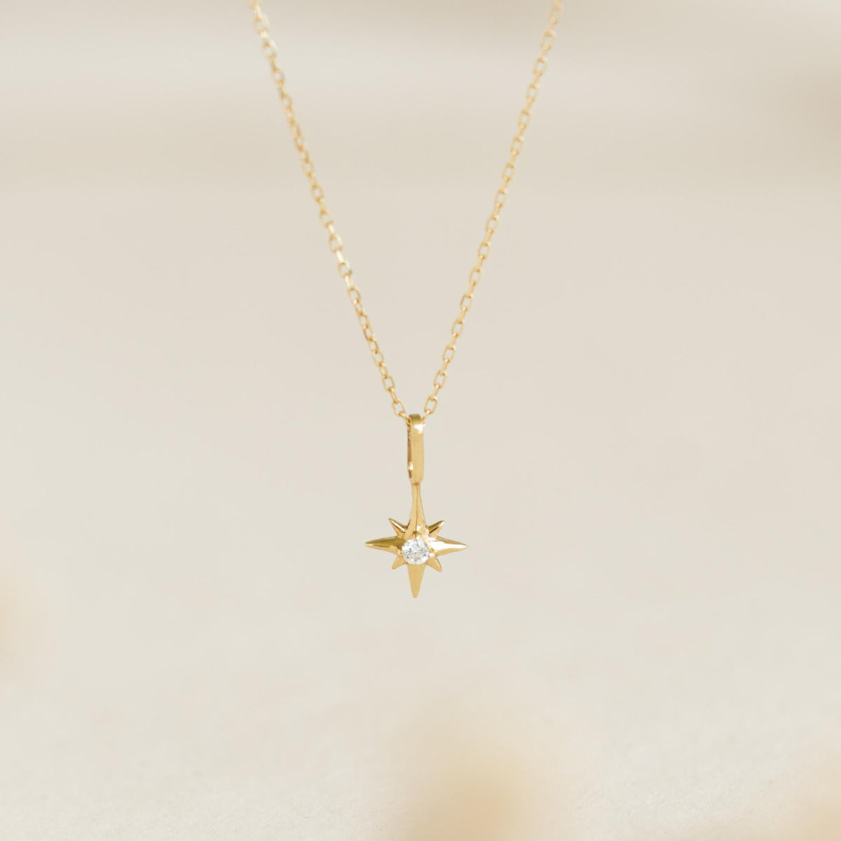 Diamond Star Charm 14k Gold necklace with a round-cut diamond set in a North Star pendant on a delicate chain