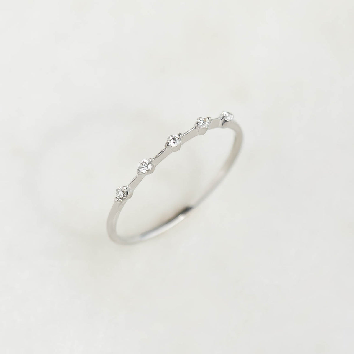 Five Stone Diamond Ring White Gold - Leoni featuring five delicate diamonds on a 14k white gold band on white background
