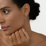 Close-up of a woman wearing Diamond Chain Earrings White Gold - Alva with delicate star diamond design on white background
