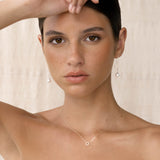 Close-up of woman wearing Pearl Threader Earrings White Gold - Anthea with delicate pearl drop and white gold chain