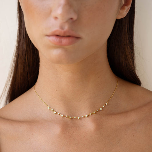 Close-up of woman wearing Gemstone Necklace - Marissa with 17 cubic zirconia stones on a gold vermeil chain