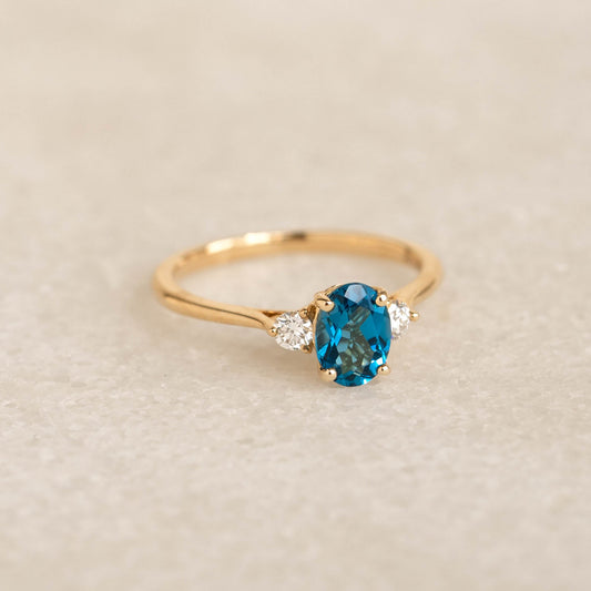 London Blue Topaz and Diamond Ring 14k Gold - Kindra with oval blue topaz and two diamonds on gold band