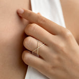 Close-up of Criss Cross Diamond Eternity Ring - Mattea featuring two rows of small diamonds on a hand against neutral background