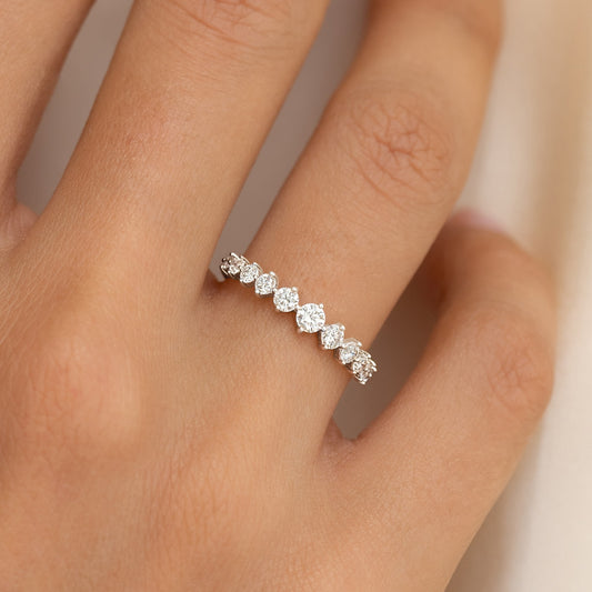 Close-up of the Graduated Diamond Ring White Gold - Giselle on a hand showing the varying diamond sizes on the band