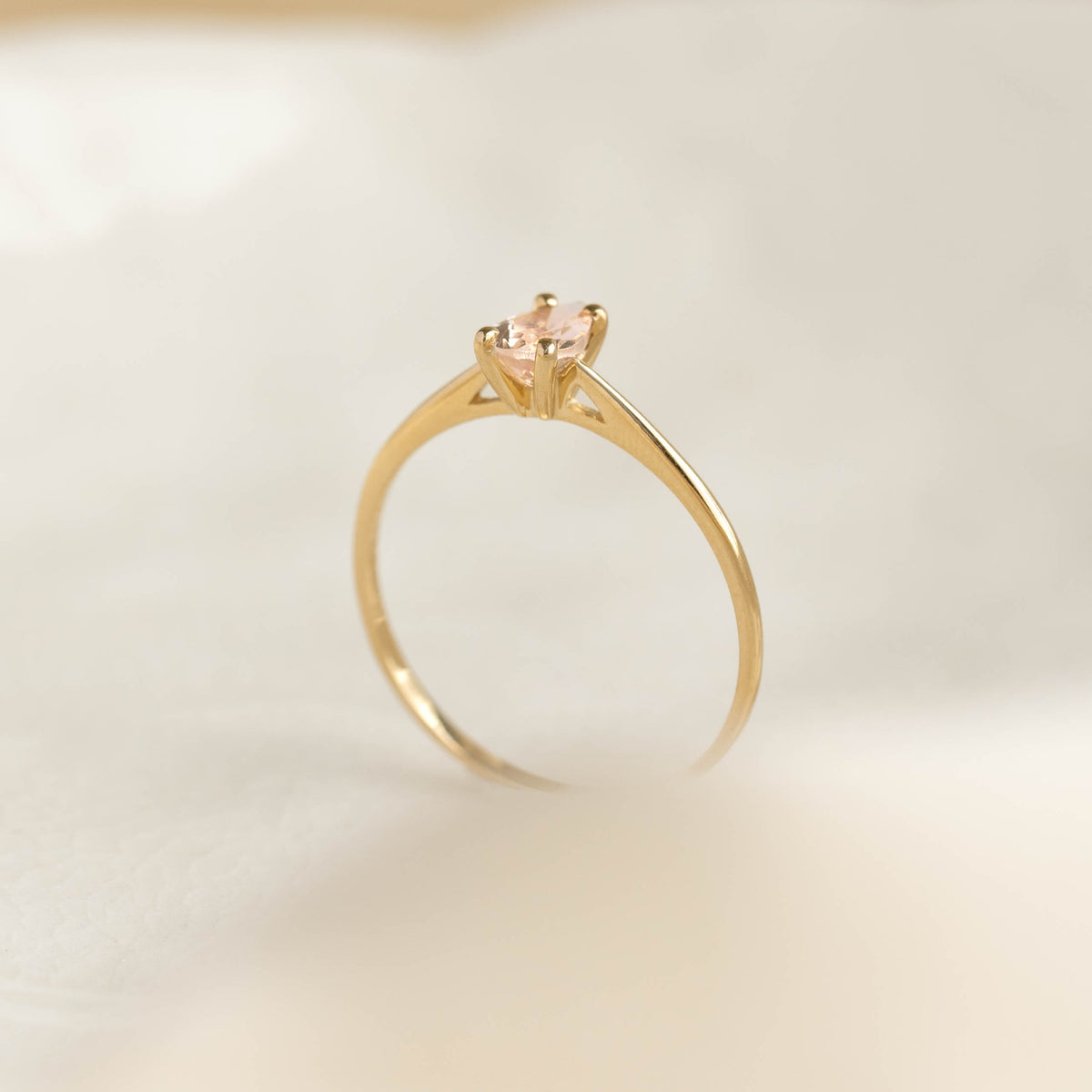 Pear Shaped Morganite Ring 14k Gold - Martine with pear-cut morganite set on a delicate yellow gold band on soft white background