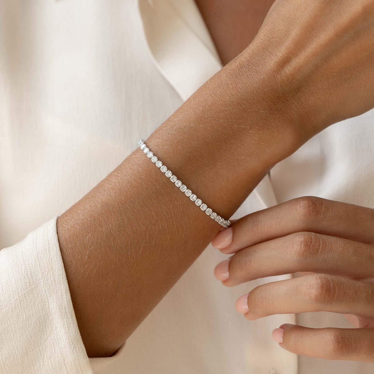Close-up of a wrist wearing the Tennis Bracelet Silver - Zilla with cubic zirconia stones on a neutral background