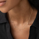 Close-up of 5-Diamond Necklace 14k Gold - Bette with five bezel-set diamonds on delicate gold chain worn on neck