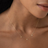 Close-up of 3-Diamond Necklace 14k Gold - Eira featuring three bezel-set diamonds on a delicate gold chain