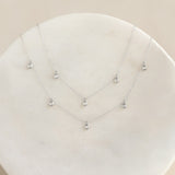 5-Diamond Necklace White Gold - Bette featuring five bezel-set diamonds on a delicate white gold chain on a neutral surface