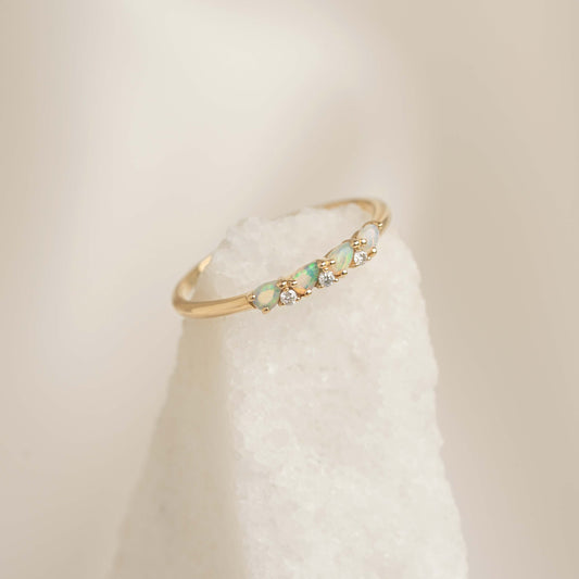 Close-up of October Birthstone Pear Ring 14k Gold - Opal and Diamond with delicate opal and diamond stones on gold band