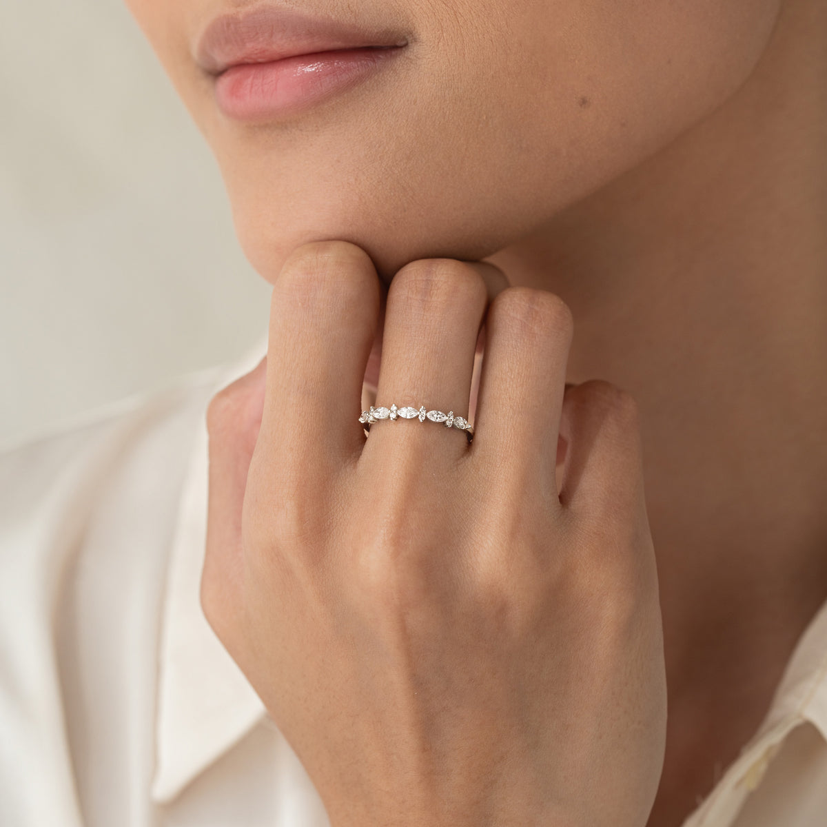 Close-up of a hand wearing Marquise and Round Diamond Ring White Gold - Aurelia with marquise and round stones on white gold band