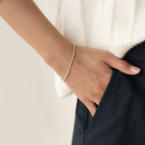 Close-up of a wrist wearing the Diamond Tennis Bracelet 14k Gold (1.62 ct tw) - Mirella against a neutral background