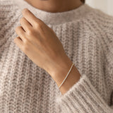 Close-up of a wrist wearing the Tennis Bracelet - Audrey featuring sparkling cubic zirconia stones on a gold vermeil chain