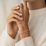 Close-up of a wrist wearing the Tennis Bracelet - Audrey with cubic zirconia stones and a gold vermeil chain