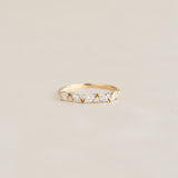 Close-up of Marquise and Round Diamond Ring 14k Gold - Celia with floral diamond details on a neutral background