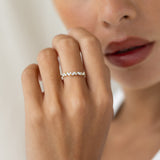 Close-up of a hand wearing the Marquise and Round Diamond Ring 14k Gold - Celia with marquise and round diamonds