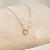 Close-up of the Diamond Sun Necklace 14k Gold - Leda featuring a delicate gold chain with a diamond sun pendant
