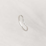 Close-up of the Graduated Diamond V Ring White Gold - Liora featuring five sparkling diamonds on a sleek band