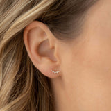 Close-up of an ear wearing Diamond Climber Stud Earrings 14k Gold - Rhea with lab grown diamonds on blonde hair background