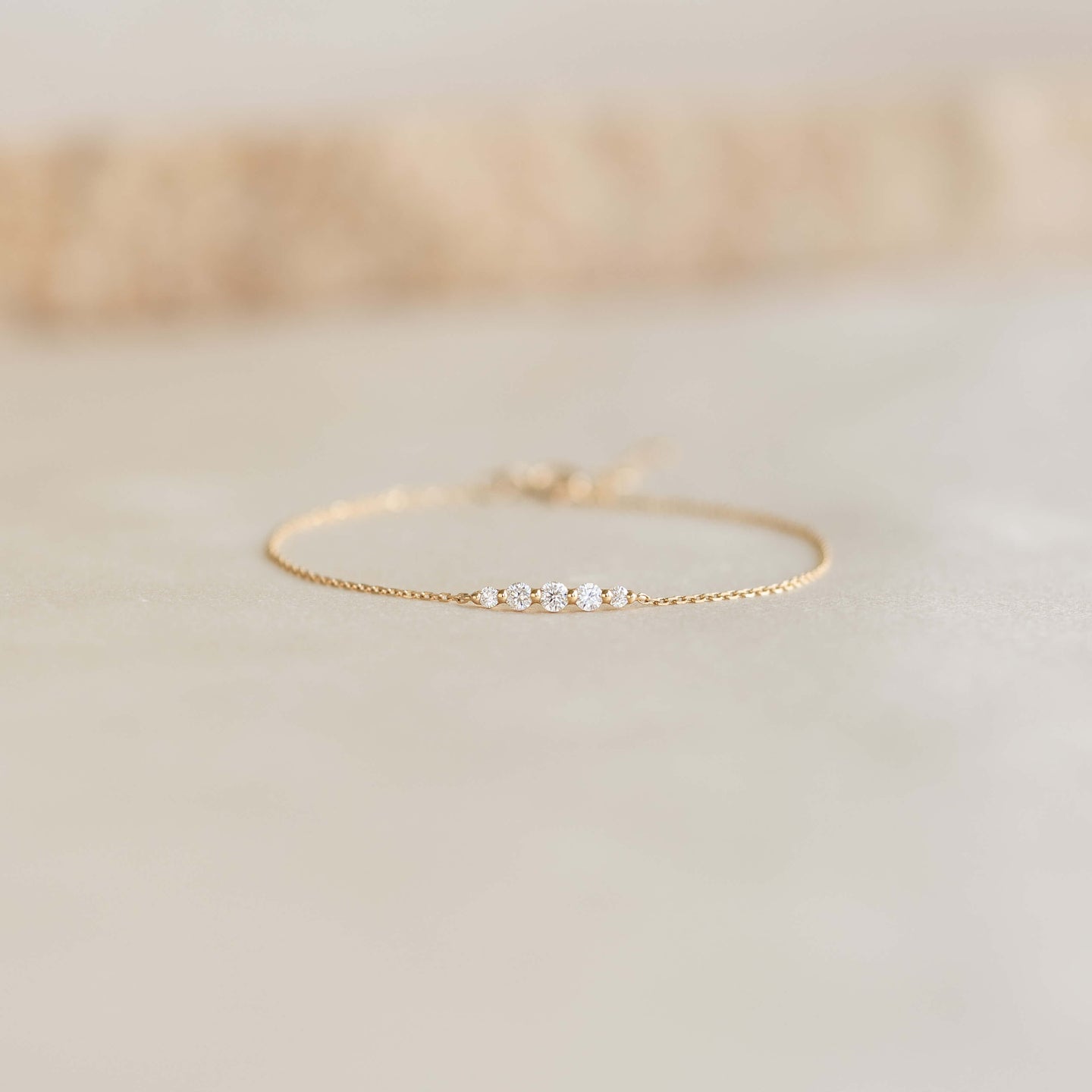 Close-up of the Graduated Diamond Bracelet 14k Gold - Tamsin with five diamonds on a delicate gold chain