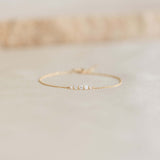 Close-up of the Graduated Diamond Bracelet 14k Gold - Tamsin with five diamonds on a delicate gold chain