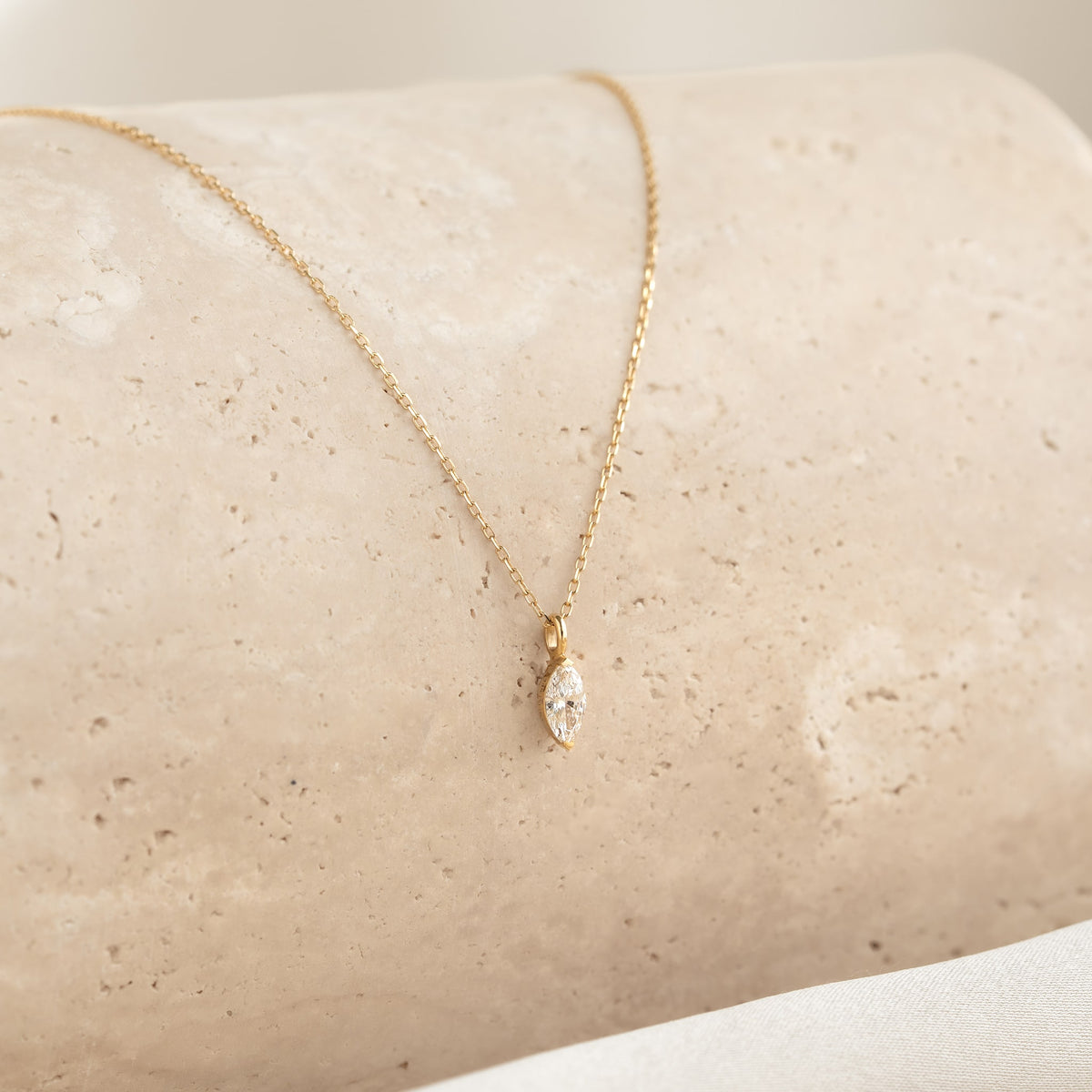 Close-up of Marquise Diamond Necklace 14k Gold - Violetta with a delicate marquise diamond pendant on a gold chain