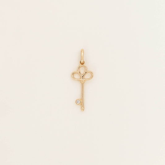 Yellow Gold key-shaped pendant design and polished finish, shown against a light neutral background.
