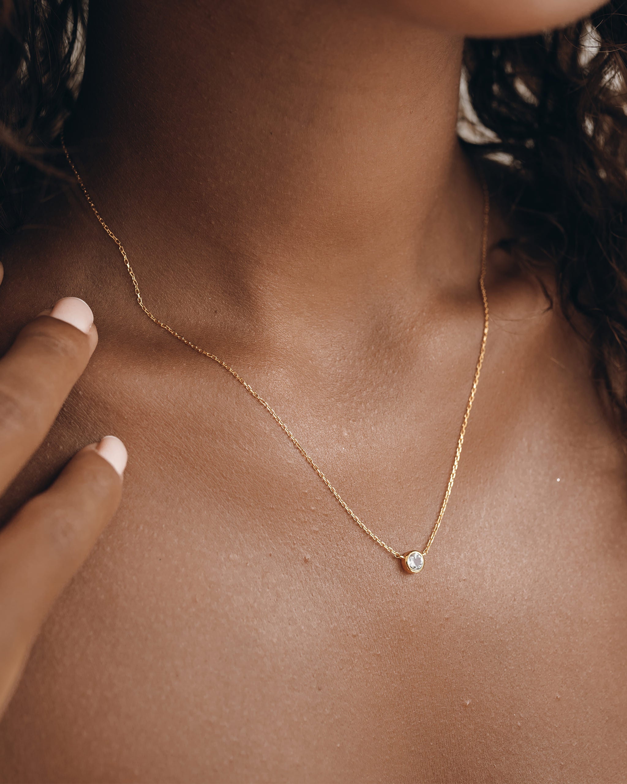 Gemstone necklace with white topaz on gold chain