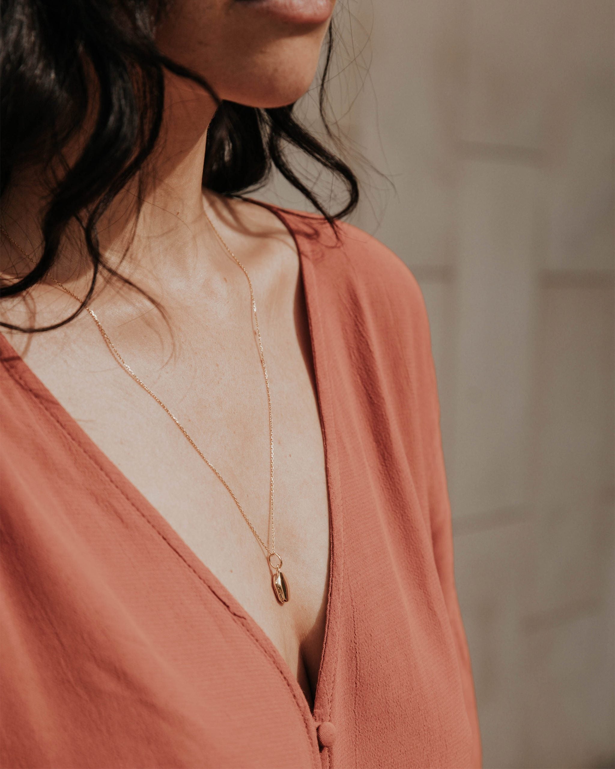Pendant necklace with locket on gold vermeil chain on model