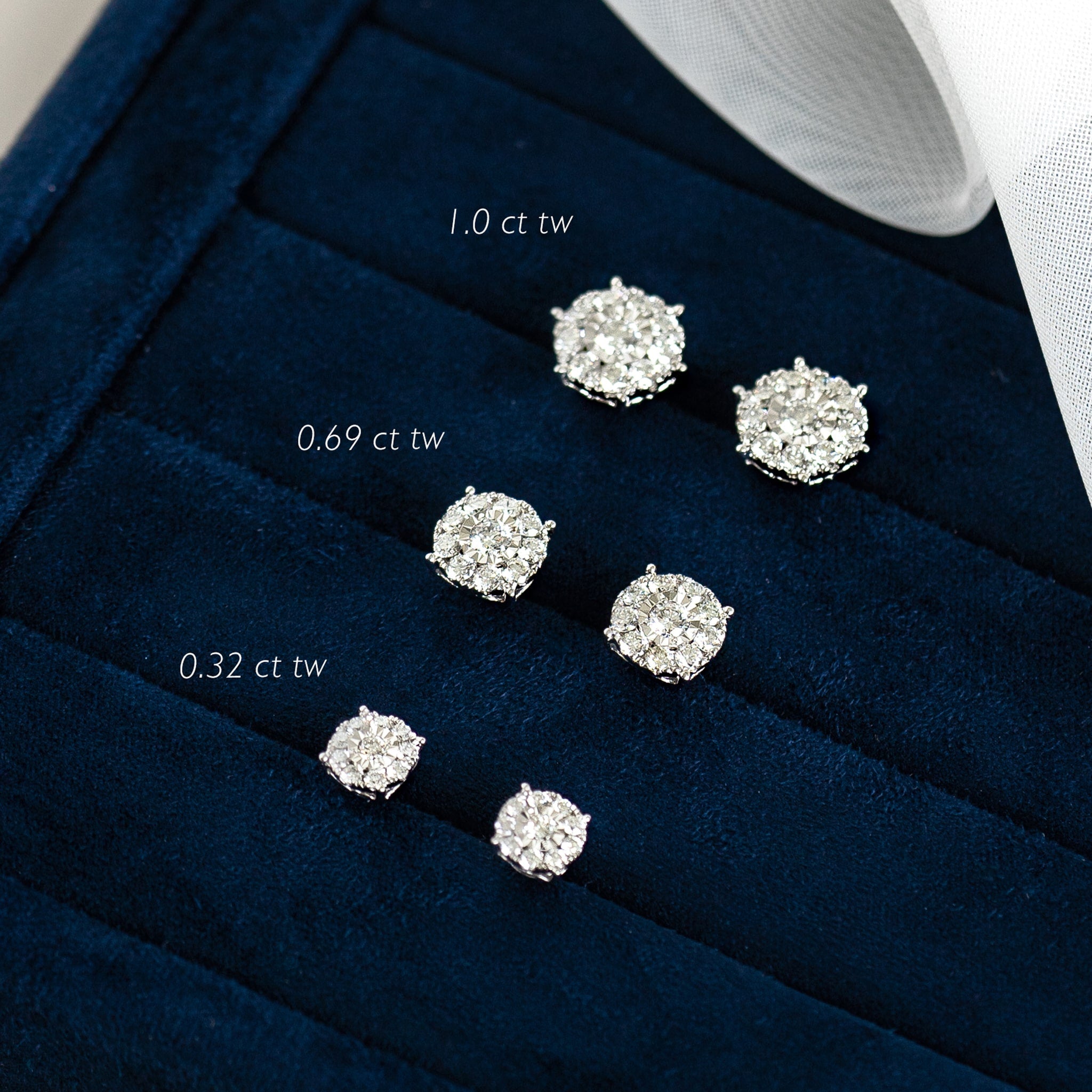 Three pairs of Diamond Earrings - 1 Carat Miracle Plate in 14k white gold displayed on a navy velvet tray
